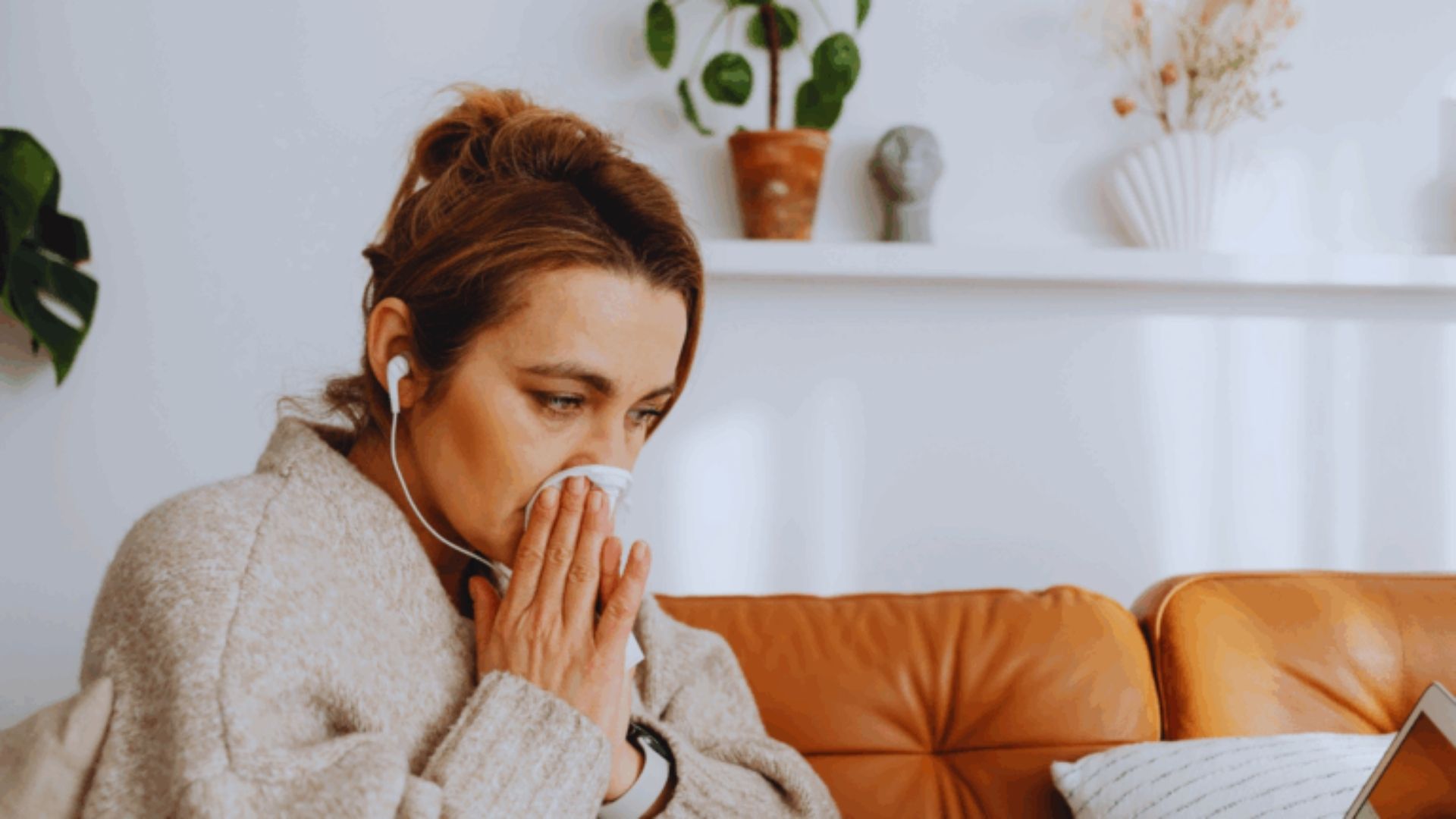 woman blowing her nose into a tissue