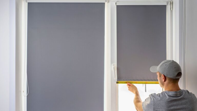 energy-efficient blinds in michigan man measuring window for blind installation gray blinds