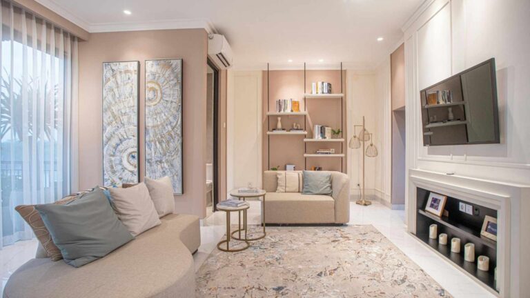 modern white living room with a cohesive flow and style, with TV on the wall and white curtains